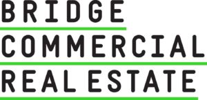 The text Bridge in black letters underlined in green, stacked on the text Commercial in black lettering and underlined in green, stacked on the text Real Estate in black lettering and underlined in green.